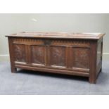 A late 17th century oak coffer, with six panel top above a carved four panel front 88 x 152 x 60cm