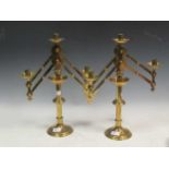 A pair of adjustable three light brass candelabra