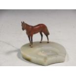 An Asprey Of London 1930's Art Deco style onyx ashtray, mounted with a cold painted figure of a