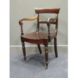 A William IV mahogany desk/ arm chair, the bar back above two scrolled arms on a dish seat raised on