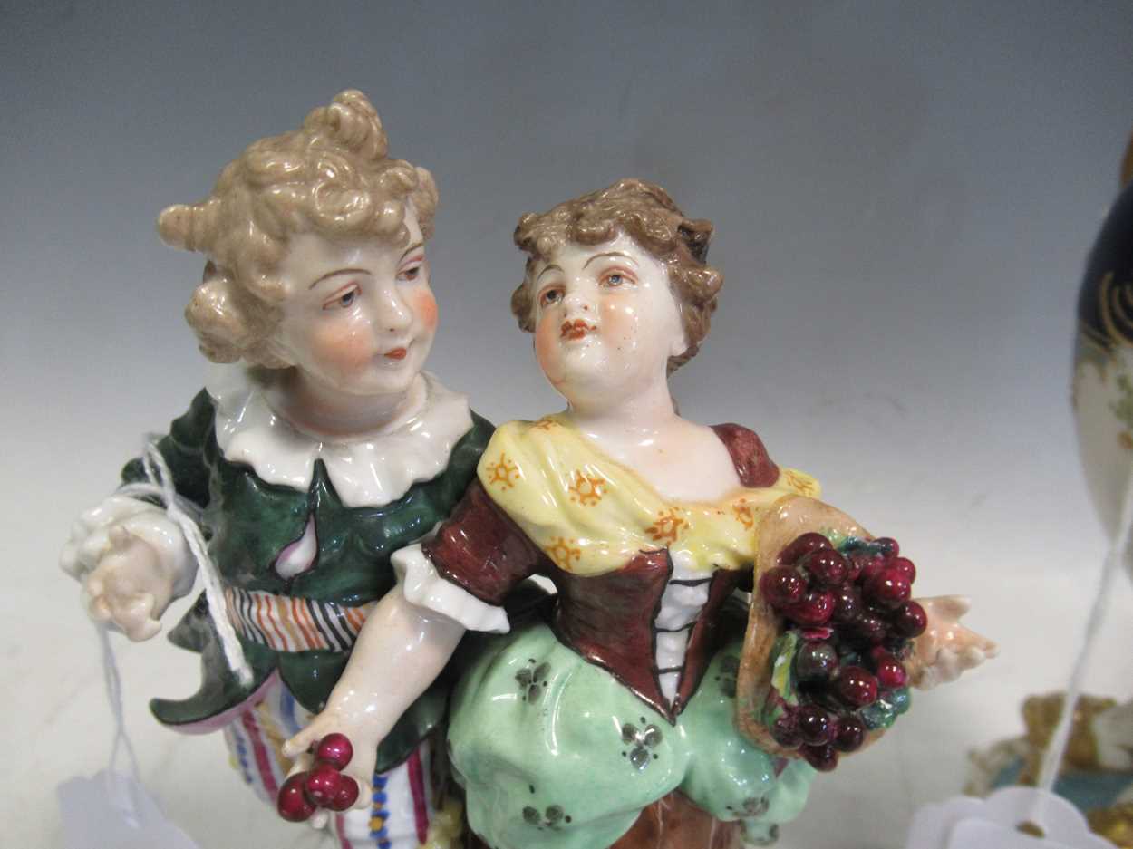 A pair of continental porcelain figurines in Meissen style and a continental porcelain vase and - Image 3 of 11