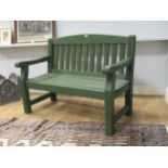 A green painted garden bench 94 x 123 x 62cmProvenance:Landwade Hall, Exning, Suffolk