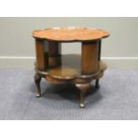 An early 20th century walnut revolving book or occasional table, 56 x 66 cm diameter