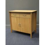 A contemporary bow-fronted pale oak side cabinet,