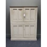 A Victorian white painted pine cupboard, the panelled doors with circular vents on plinth base 163 x