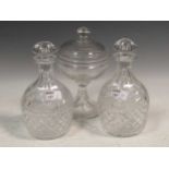 Two glass decanters and pedestal bowl and cover