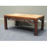 A Chinese hardwood coffee table, the rectangular top above a fret cut frieze, 30 x 70 x 41cm (A/F)