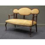 An Edwardian Arts & Crafts mahogany settee, of slender form with shaped back, 115 cm wideCondition