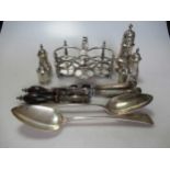A collection of silver including a cruet stand and spice caster, a pair of pepperettes and a pair of