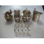 Three silver jugs, a silver sugar bowl and a silver toastrack 17ozt