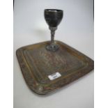 A Middle Eastern goblet set with oval green cabochons together with a metal tray in a similar style