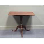 A George III mahogany tilt top tripod table on vase shaped column and tripod base with blacksmith