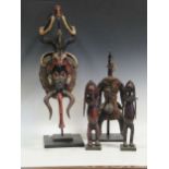 A pair of Nyamwezi carved wood figures with articulated arms 33cm high, together with a painted