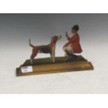 A painted carved wooden cut out of a hunstmen and hound, signed Reginald Day dated 1925, 17 x 28 x