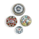 A group of four glass paperweights,