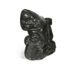 An Inuit carved stone figure of a mother with her children,