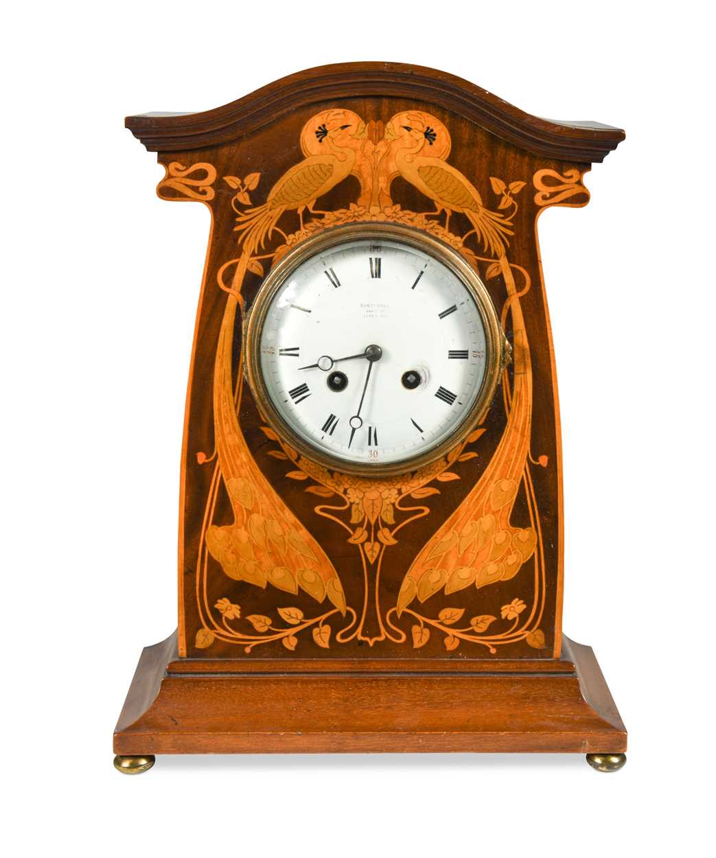 An Art Nouveau inlaid mahogany mantle clock,