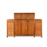 A large Heal's 'Buttery Hutch' wardrobe, circa 1930, with central triple wardrobe flanked to