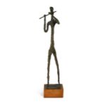 A Giacometti style bronze figure of a musician,