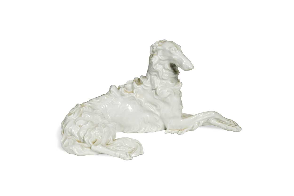 A Vienna porcelain blanc de chine model of a reclining Borzoi,