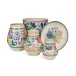 A small collection of Poole Pottery, circa 1960, decorated with bouquets of flowers and birds amidst