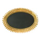 A large mid-century gilt metal oval sunburst mirror, the oval plate surrounded by a ropetwist border