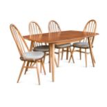 An Ercol elm 'Windsor' extending dining table and eight chairs,