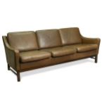 A modern brown leather three-seat sofa,