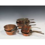 An assortment of 9 copper pans