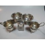 Two silver milk jugs, two silver sugar bowls and a silver topped glass cosmetics jar, 9.5ozt