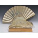 An early 20th Century French fan with needlework panel and mother of pearl sticks, 64cms wide opened