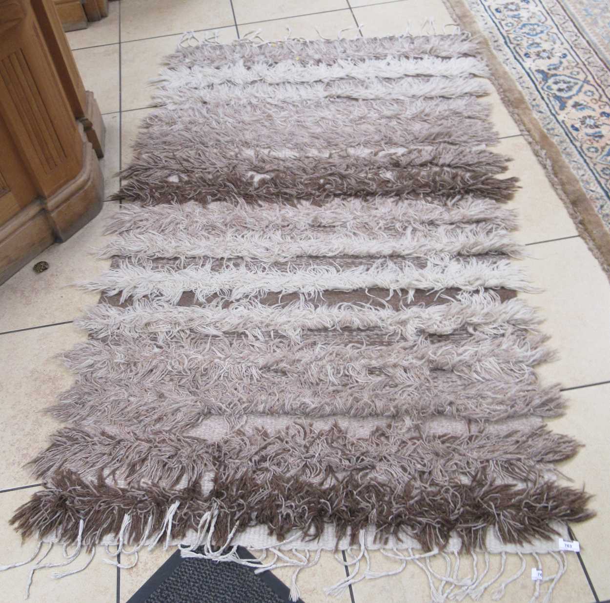A modern hand woven wool rug 200 x 110cm