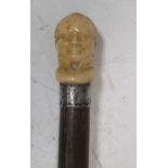 A carved ivory Napoleon head walking stick pommel, with mahogany shaft, 82.5cm long