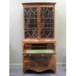 A late George III bow fronted secretaire bookcase,