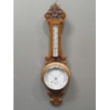 A Victorian wheel barometer by Dollond, London