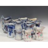 Two early 20th century Rathbone blue and gilt jugs together with various other blue and white jugs