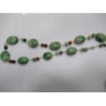 Two strings of maw sit sit beads, 20th century, and one string of nephrite beads interspersed with