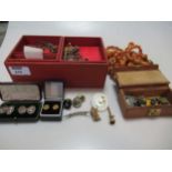 A collection of jewellery and assorted items to include three rows of amber beads, a watch key