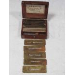 W H Harling mahogany box of brass plan template letters, words and numbers, with label