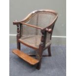 A Victorian child’s chair with hooped carved back, adjustable foot rest on a platform base, 86cms