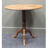 A 19th century tilt top tripod table, the circular top above a turned column support 70 x 76cm