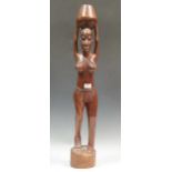 A carved tribal figure of a woman 87cm high