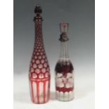 A Bohemian ruby-flashed decanter and stopper, 41cm hjigh; another engraved with vines, 33cm high