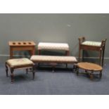 An Edwardian piano stool with needlework hinged seat, a walnut fender stool on cabriole legs,