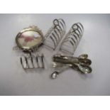 A small silver toast rack, silver circular photo frame and a pair of larger toast racks and