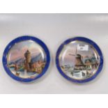 A pair of Continental porcelain plates, one painted with skaters by a windmill, the other with a