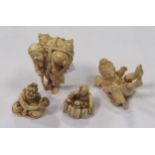 Four ivory netsukes, one of a rat catcher - 6.5cm high, a young boy playing with a cat - 5cm long