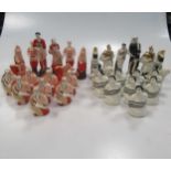 A 20th century Russian painted ceramic Propaganda chess set, (see 40), red side representing
