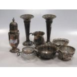 A collection of silverware including a sugar caster, christening mug, a pair of trumpet shape