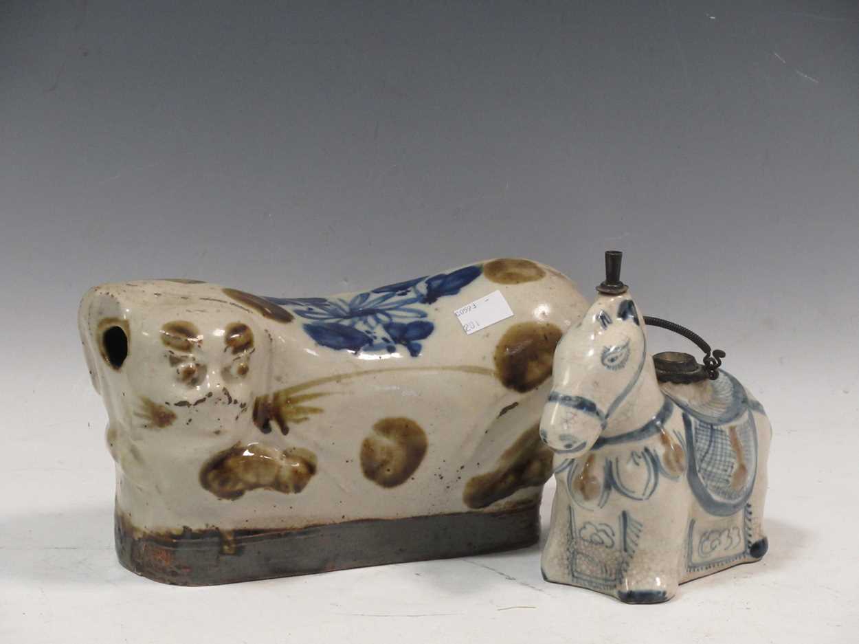 A Chinese provincial stoneware pillow as a cat, late Qing Dynasty/Republic, 24cm long